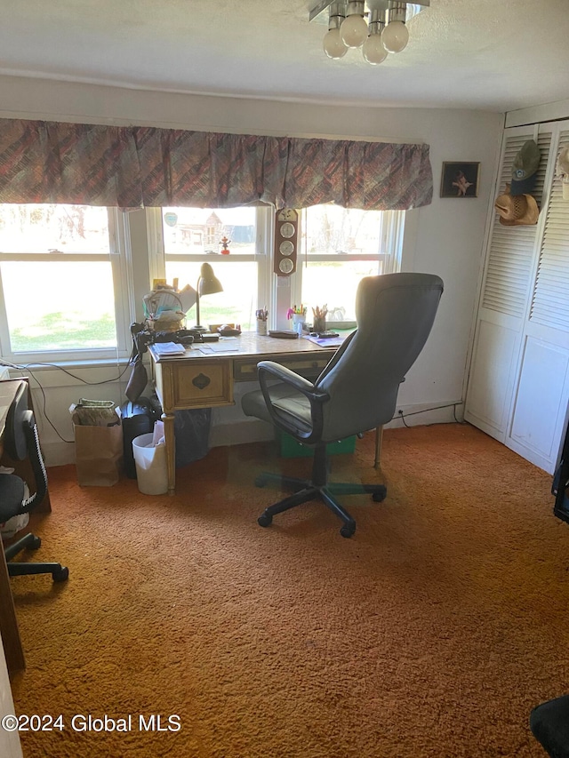 office featuring a chandelier, plenty of natural light, and carpet flooring