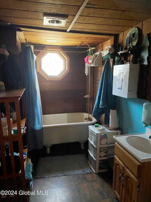 bathroom featuring wooden ceiling, wood walls, vanity, and tile floors