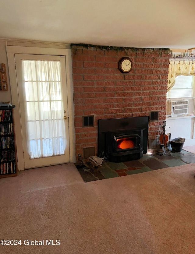 carpeted living room with plenty of natural light, a wood stove, and a fireplace