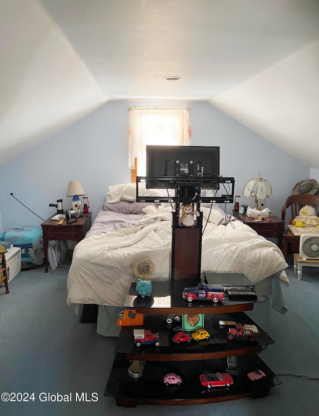 carpeted bedroom with lofted ceiling