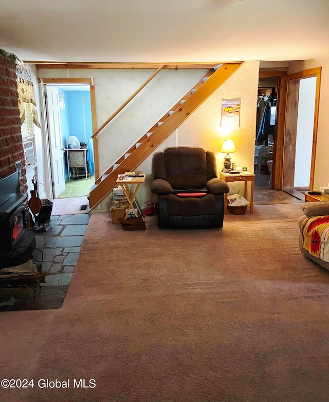 carpeted living room with a wood stove