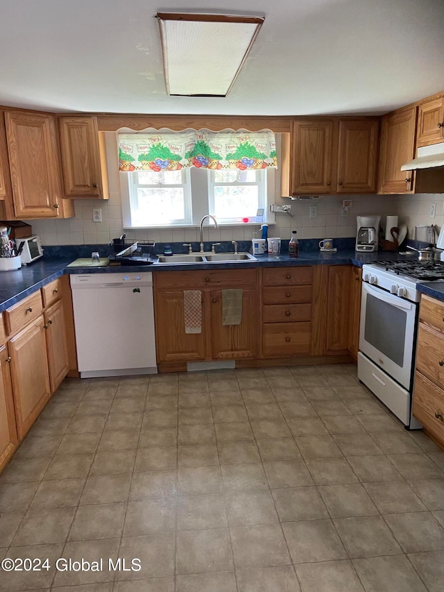 kitchen with light tile flooring, white appliances, tasteful backsplash, and sink