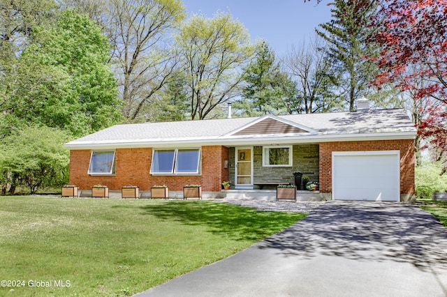 ranch-style house featuring a garage and a front yard