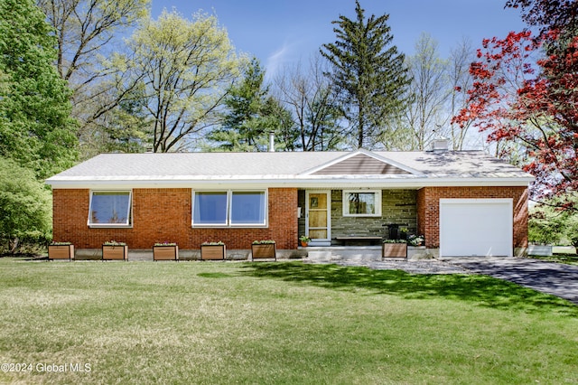 ranch-style house with a garage and a front lawn