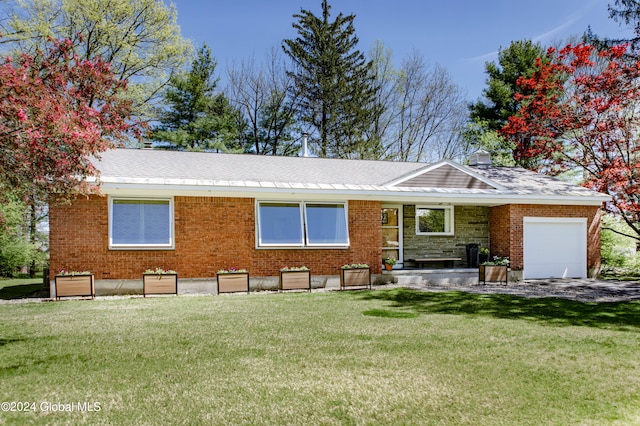 single story home featuring a garage and a front lawn