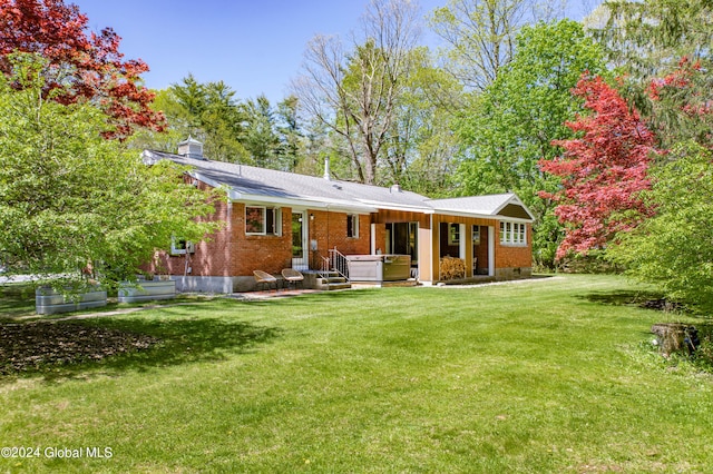 back of house featuring a lawn