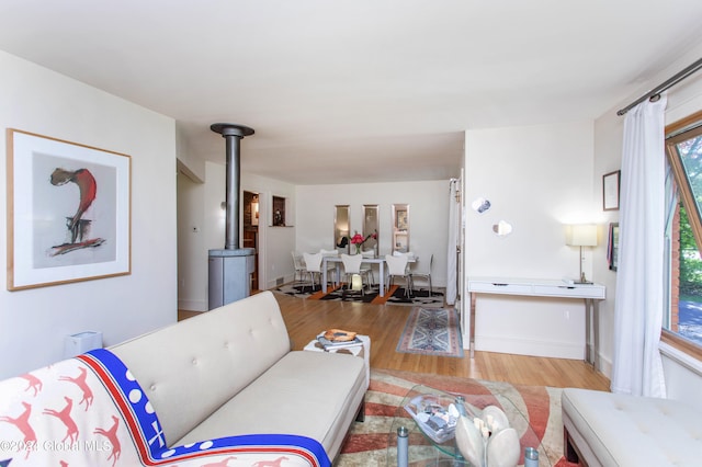 living room with hardwood / wood-style floors and a wood stove