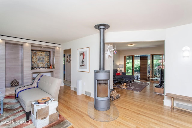 interior space featuring light hardwood / wood-style flooring and a wood stove