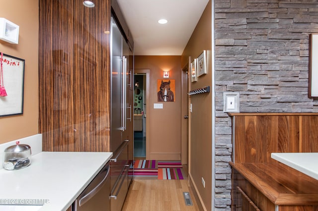 interior space featuring stainless steel dishwasher and hardwood / wood-style floors