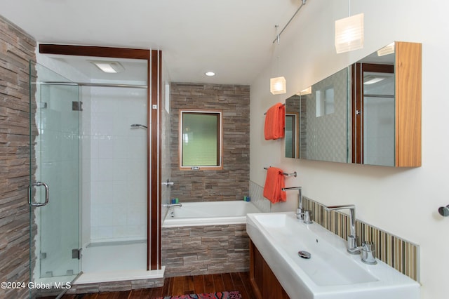 bathroom with hardwood / wood-style floors, sink, and separate shower and tub