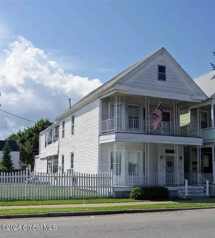 exterior space featuring a porch and a balcony