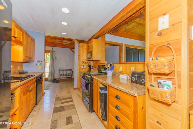 kitchen with beamed ceiling, black appliances, light stone countertops, and light tile floors