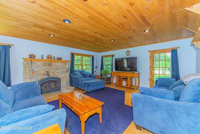 living room with a healthy amount of sunlight, a fireplace, hardwood / wood-style flooring, and wooden ceiling