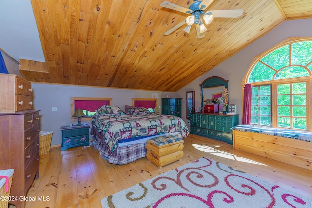 bedroom with hardwood / wood-style flooring, lofted ceiling, multiple windows, and ceiling fan