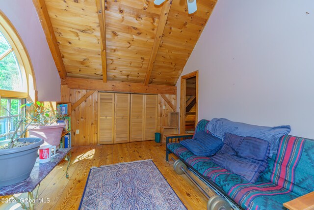 living room featuring wooden ceiling, lofted ceiling with beams, ceiling fan, and hardwood / wood-style floors