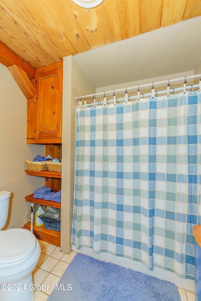 bathroom featuring tile flooring, toilet, and wood ceiling