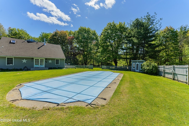 view of pool with a yard