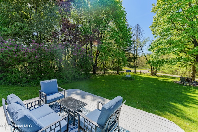 wooden deck with an outdoor hangout area and a yard