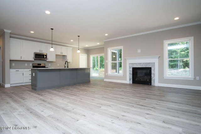 6 Killington Ln, Johnstown, NY 12095 - kitchen with range, white cabinetry, stainless steel microwave, and crown molding