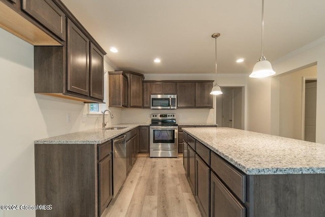 6 Killington Ln, Johnstown, NY 12095 - kitchen featuring dark brown cabinets, ornamental molding, a sink, light wood-style floors, and stainless steel appliances
