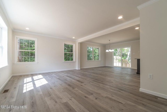 6 Killington Ln, Johnstown, NY 12095 - empty room with wood finished floors, visible vents, a chandelier, crown molding, and baseboards