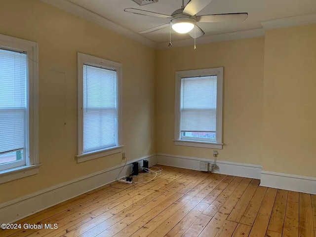 spare room with a healthy amount of sunlight, light wood-type flooring, and ceiling fan