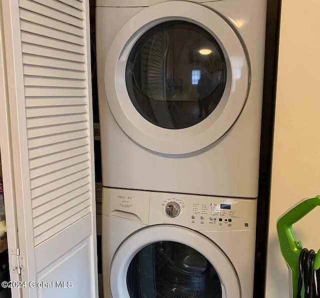 laundry area with stacked washer / drying machine