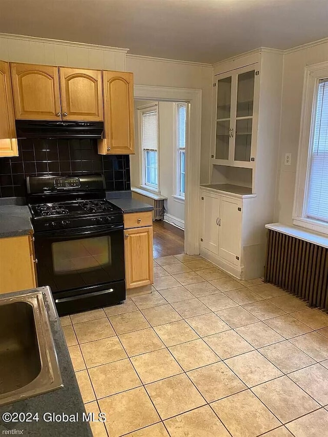 kitchen featuring ventilation hood, black gas stove, backsplash, sink, and radiator heating unit