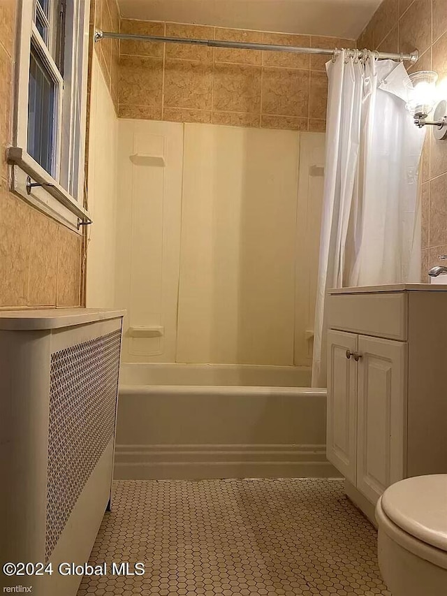 full bathroom with tile floors, toilet, and shower / bath combo