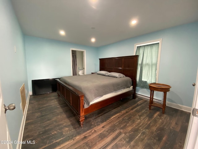 bedroom with dark hardwood / wood-style floors