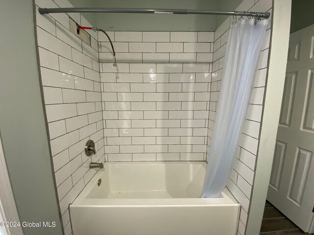 bathroom with shower / tub combo with curtain