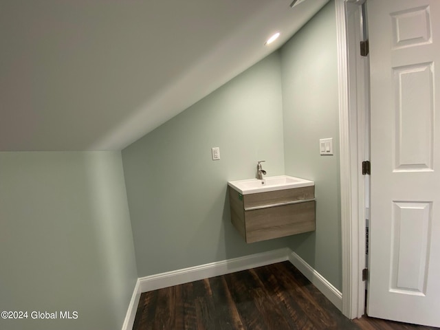 bathroom featuring lofted ceiling, wood-type flooring, and sink