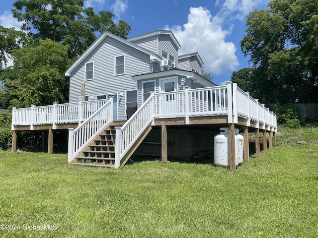 rear view of house with a yard and a deck