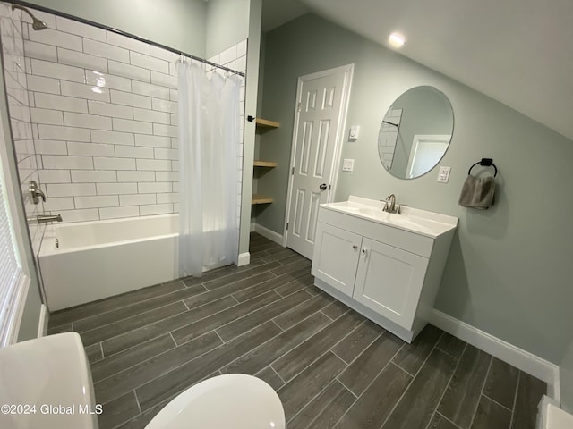 full bathroom with vanity, lofted ceiling, shower / tub combo, and toilet