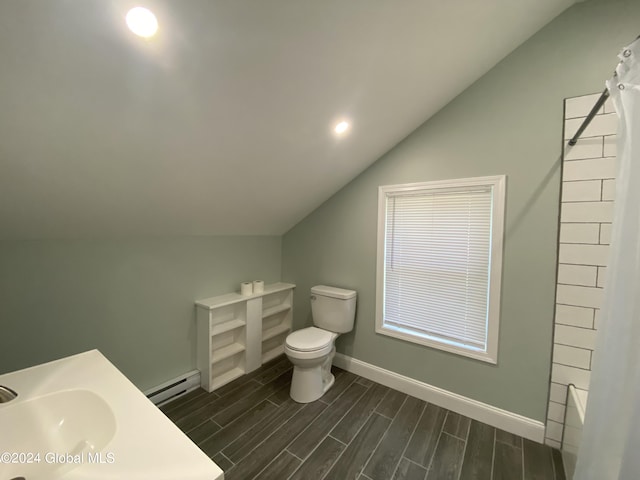 full bathroom featuring vaulted ceiling, sink, baseboard heating,  shower combination, and toilet