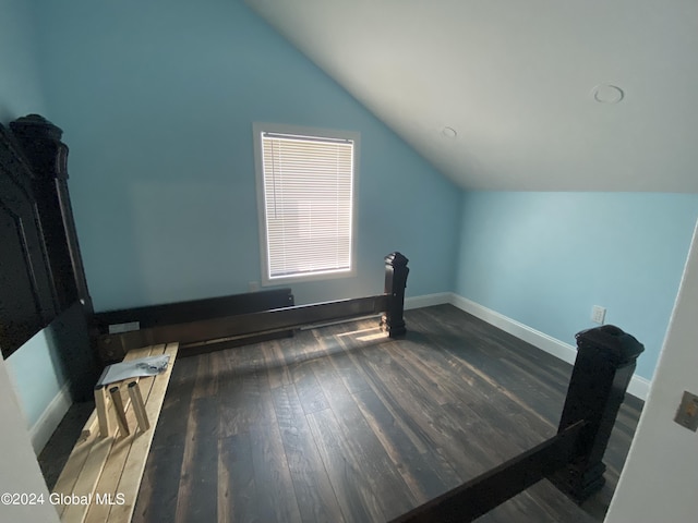 bonus room featuring lofted ceiling and dark hardwood / wood-style flooring