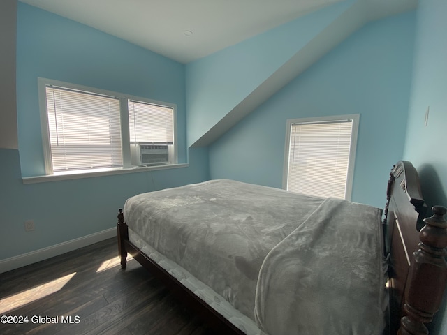 bedroom with cooling unit, dark hardwood / wood-style floors, and vaulted ceiling