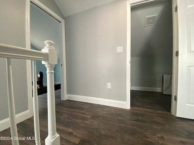 interior space with lofted ceiling and dark hardwood / wood-style flooring