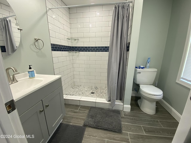 bathroom featuring vanity, toilet, and walk in shower