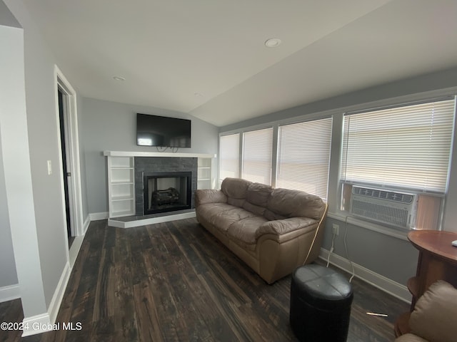 living room featuring lofted ceiling, dark hardwood / wood-style flooring, and a tile fireplace