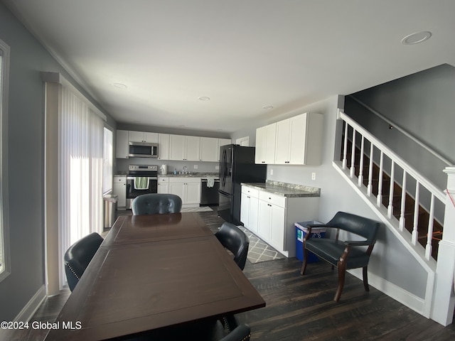 dining area featuring dark wood-type flooring and sink