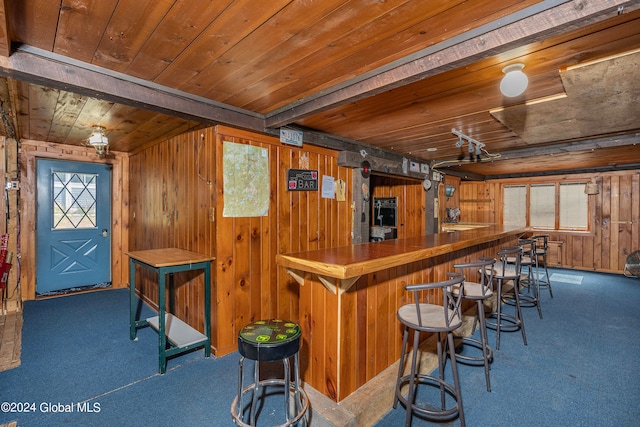 bar with carpet, wooden walls, and wood ceiling