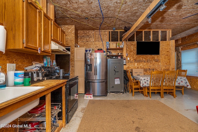 kitchen featuring stainless steel fridge and black range with electric stovetop