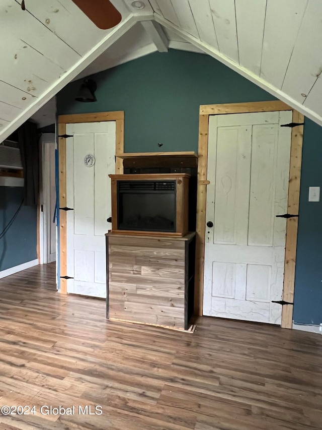 interior space featuring wood-type flooring and vaulted ceiling with beams