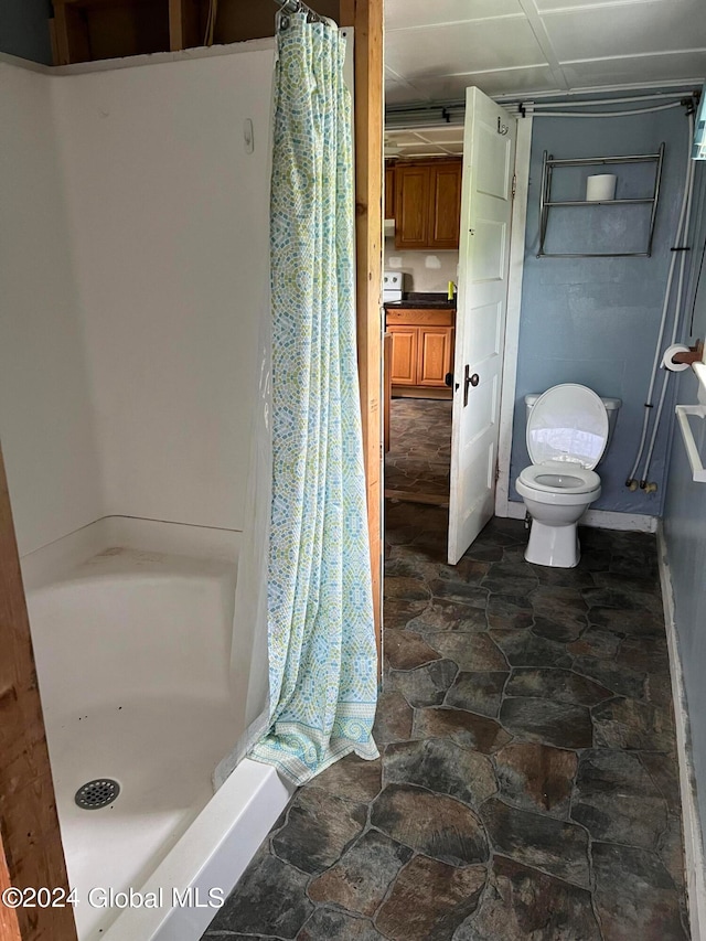 bathroom with curtained shower, tile flooring, and toilet