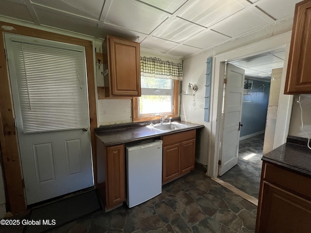 16603 State Route 22, Putnam, NY 12861 - kitchen with a sink, dark countertops, fridge, and dark stone finish floors