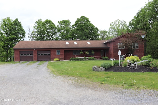 view of front of home with a garage and a front yard