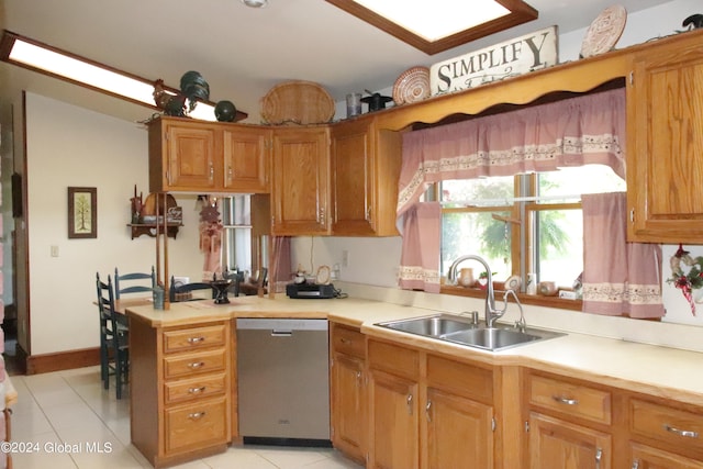 kitchen featuring sink, light tile floors, and stainless steel dishwasher