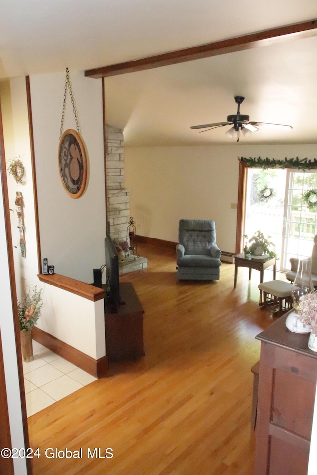 unfurnished living room featuring wood-type flooring, ceiling fan, and vaulted ceiling