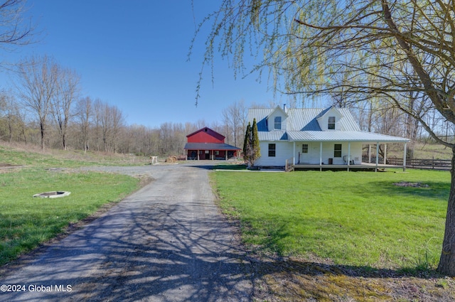 farmhouse inspired home with a front lawn and covered porch